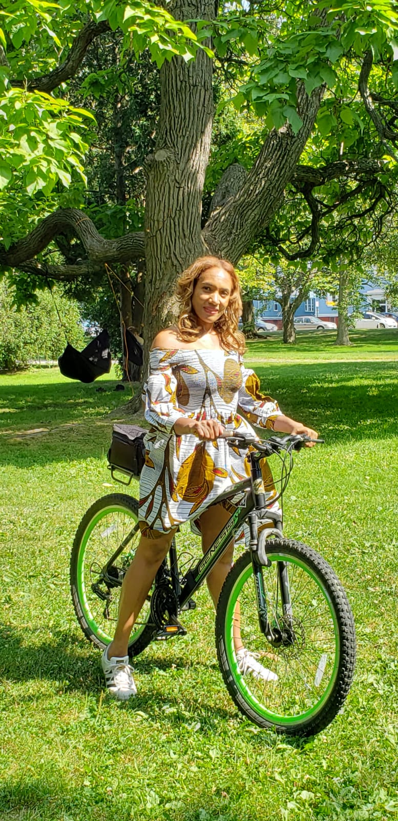 The Sunburst Off-Shoulder Dress – white Ankara mini dress with bold yellow and green print