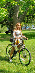 The Sunburst Off-Shoulder Dress – white Ankara mini dress with bold yellow and green print