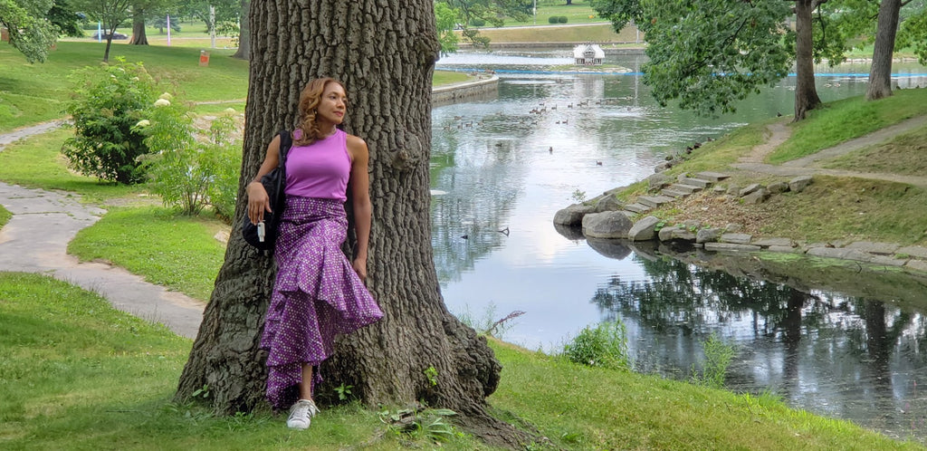 The Vivid Ruffle Maxi Skirt — lakeside park shot in violet polka-dot Ankara print