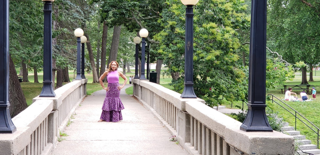 The Vivid Ruffle Maxi Skirt — bridge editorial shot in violet polka-dot Ankara print